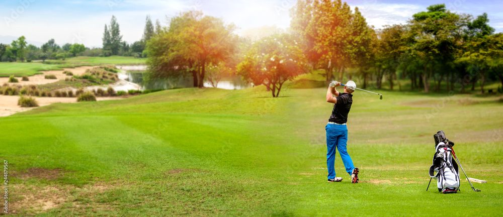 A golfer finishing a swing on a sunlit fairway, with a golf bag beside him and a pond and trees behind